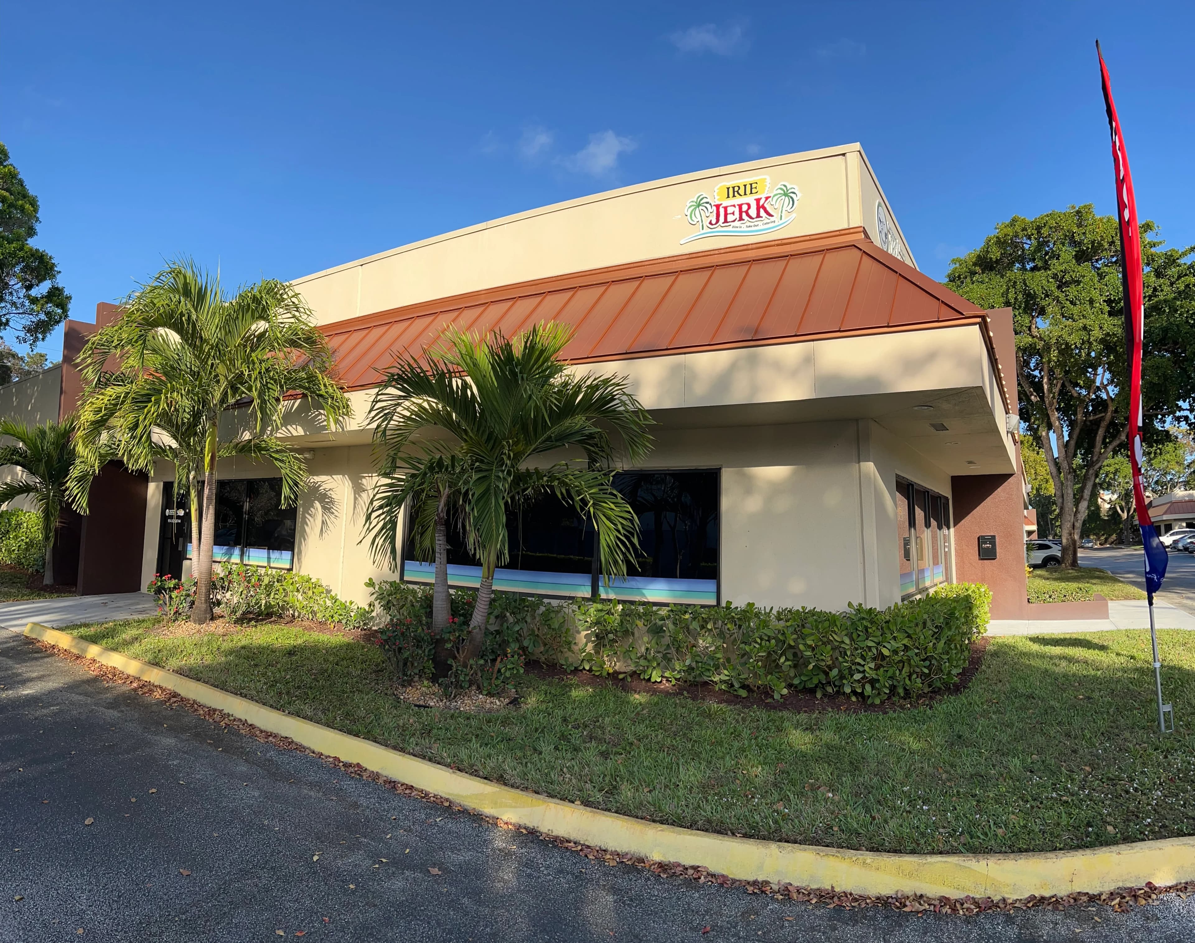 Irie Jerk restaurant exterior with tropical landscaping
